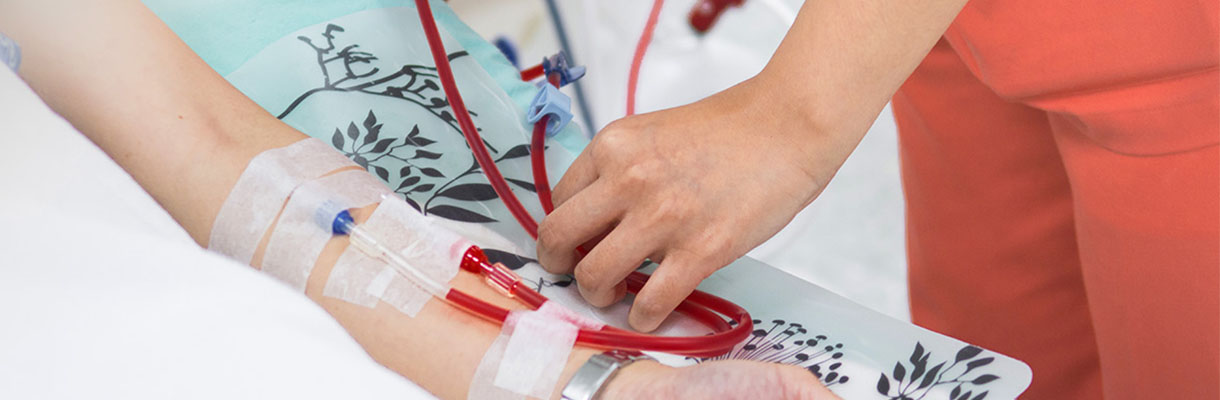 A person demonstrates using a blood pressure monitor for assessment.